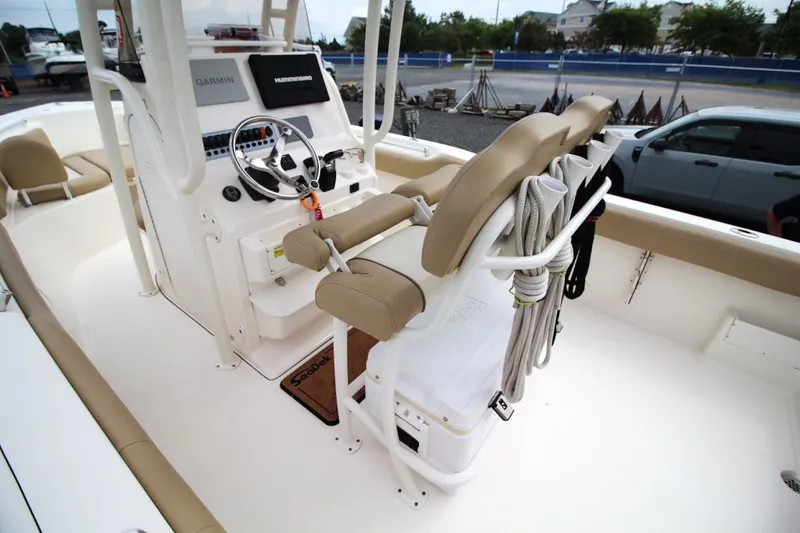 Slide: The Image of 2018 Key West 239 FS boat interior with helm, seating, and ropes. - 13