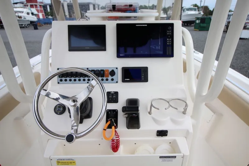 Slide: The Image of 2018 Key West 239 FS boat console with steering wheel and navigation displays. - 14