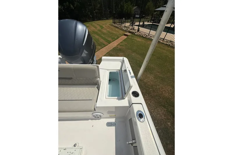 Slide: The Image of 2022 Sportsman Masters 227 Bay Boat interior with seating and storage compartments. - 17