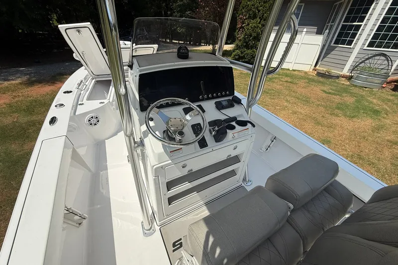 Slide: The Image of 2022 Sportsman Masters 227 Bay Boat interior with steering console and seating. - 18
