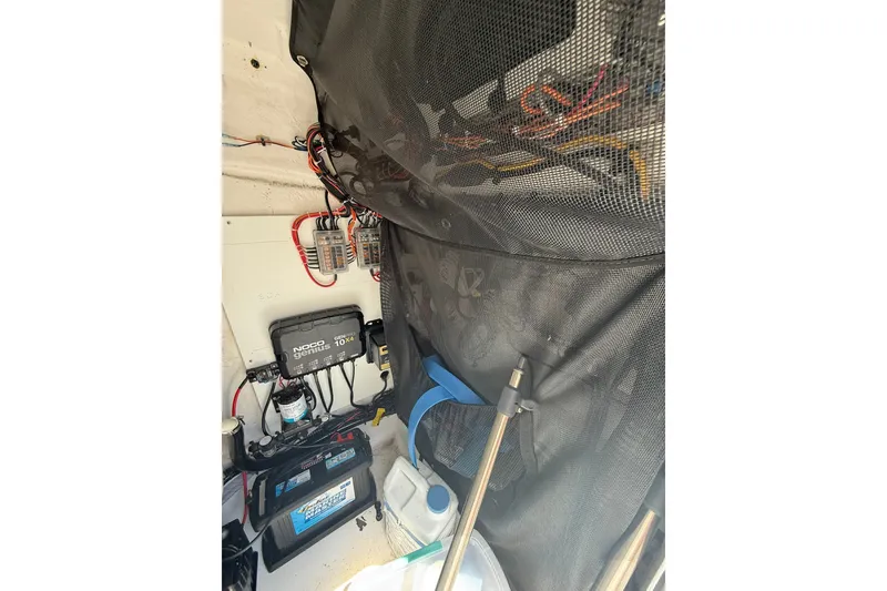 Slide: The Image of Interior view of a 2022 Sportsman Masters 227 Bay Boat's electrical components and wiring. - 19