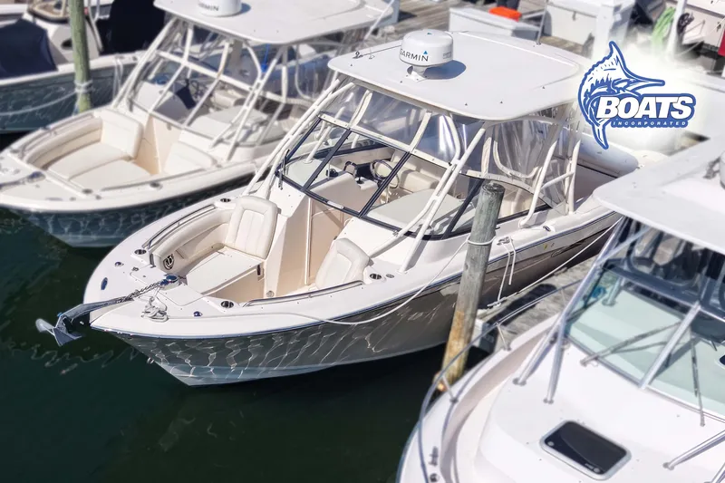 The Image of 2015 Grady-White Freedom 275 boat docked, featuring sleek design and spacious seating. - 0