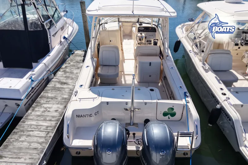 Slide: The Image of 2015 Grady-White Freedom 275 boat docked, featuring dual engines and spacious seating. - 14