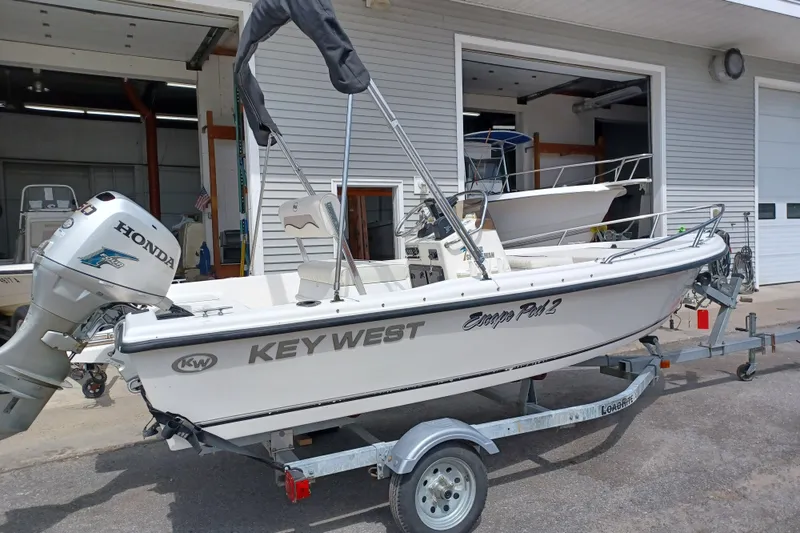 The Image of 2010 Key West 1520 Center Console boat on trailer with Honda outboard motor. - 0
