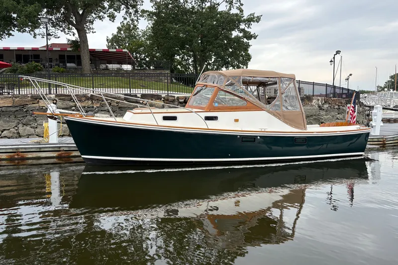 The Image of 2003 Dyer 29 Soft Top boat docked in a marina, featuring a classic design. - 1