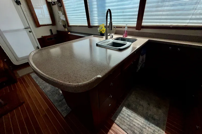 Slide: The Image of Luxurious kitchen interior of a 2016 Nordic Tug 44 boat with modern countertops and sink. - 41