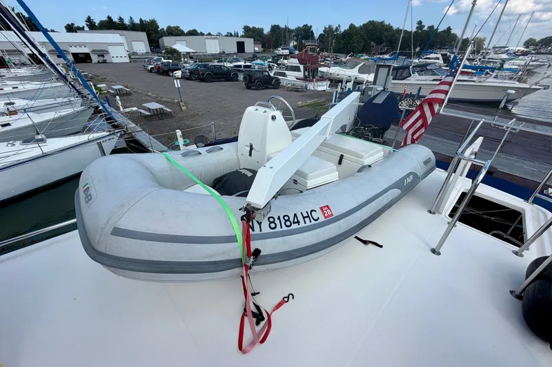 Slide: The Image of Inflatable boat on 2016 Nordic Tug 44 at marina, surrounded by other boats and vehicles. - 28