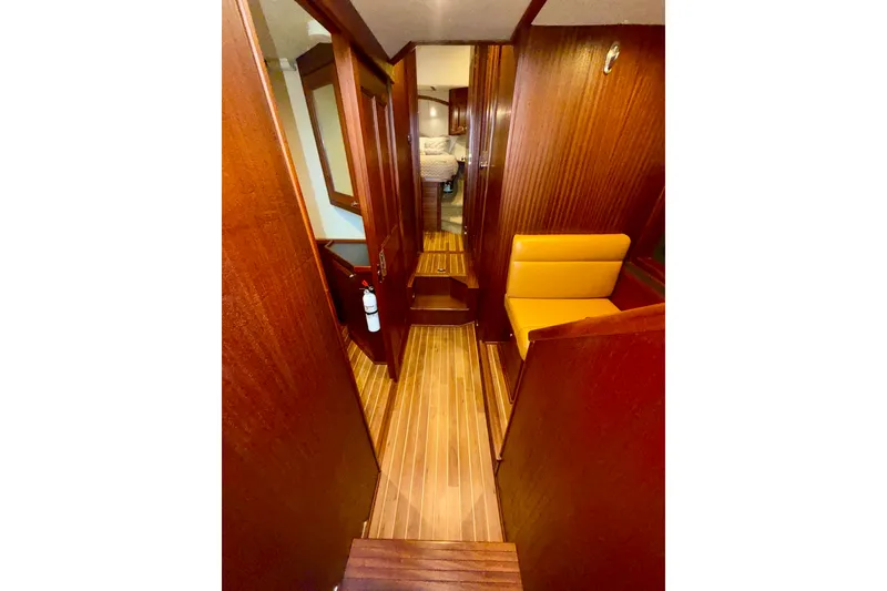 Slide: The Image of 2016 Nordic Tug 44 interior with wood paneling and yellow seating. - 67