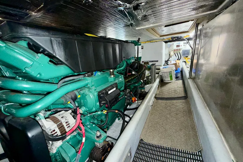 Slide: The Image of Engine room of a 2016 Nordic Tug 44, featuring a green marine engine. - 86