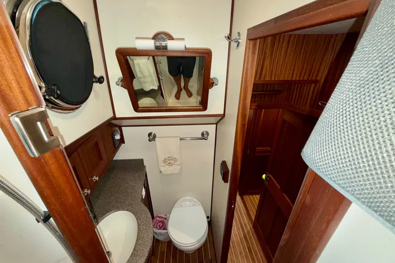 Slide: The Image of Bathroom interior of 2016 Nordic Tug 44 with wooden accents and modern fixtures. - 80