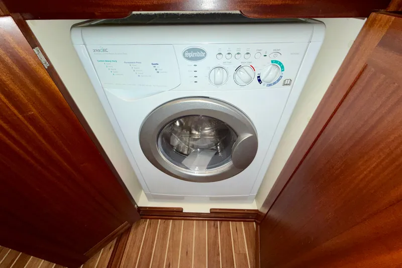 Slide: The Image of Washing machine in 2016 Nordic Tug 44 boat interior, surrounded by wooden cabinetry. - 77