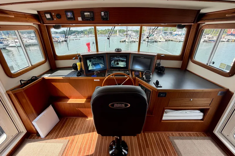 Slide: The Image of Pilothouse of 2016 Nordic Tug 44 with navigation equipment and marina view. - 45