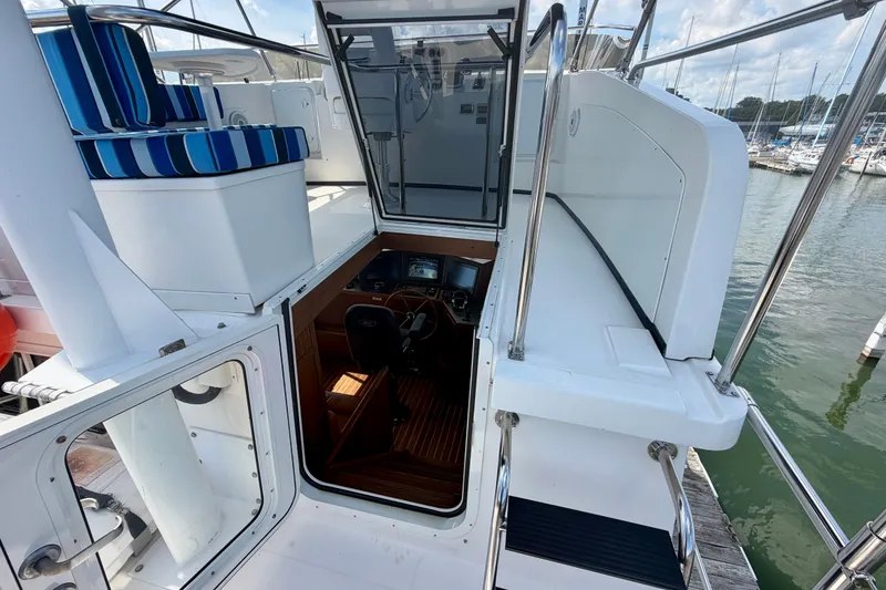 Slide: The Image of 2016 Nordic Tug 44 boat interior with striped seating and helm station. - 23