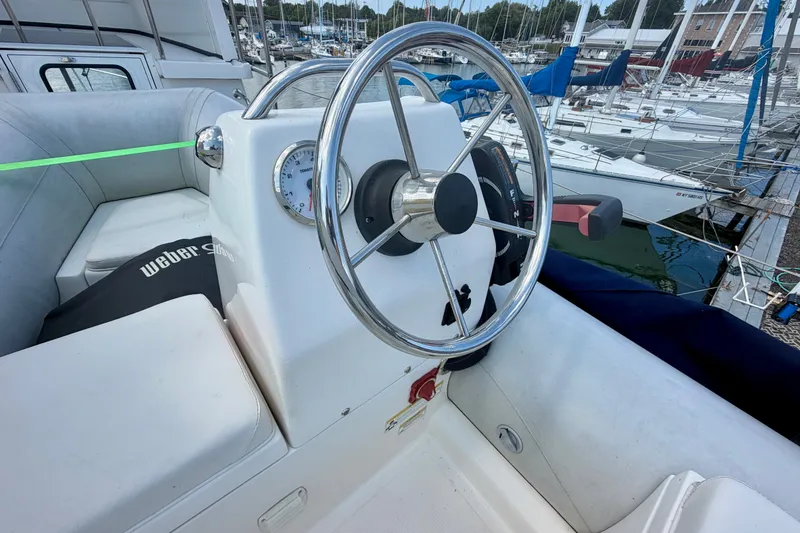 Slide: The Image of Steering wheel of a 2016 Nordic Tug 44 boat docked at a marina. - 29
