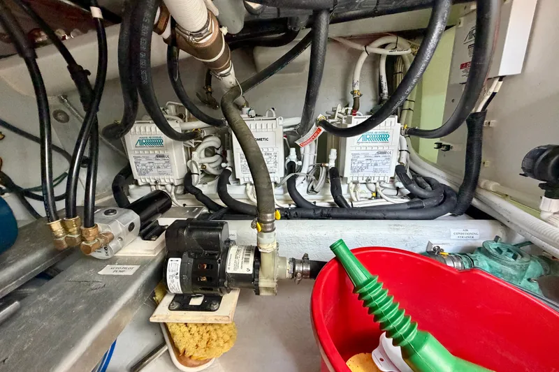 Slide: The Image of Engine room of a 2016 Nordic Tug 44 with various mechanical components and hoses. - 113