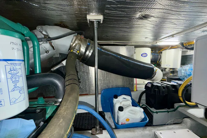 Slide: The Image of Engine room of a 2016 Nordic Tug 44 with hoses and containers. - 100