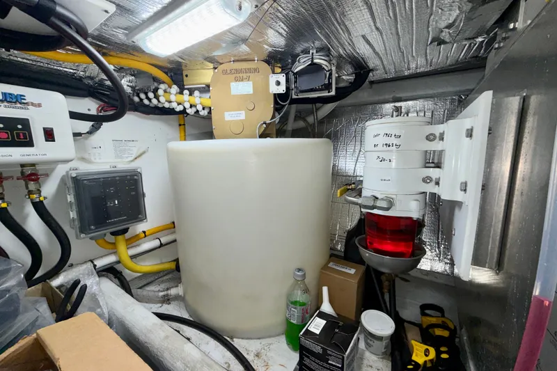 Slide: The Image of Engine room of a 2016 Nordic Tug 44 with various equipment and wiring. - 94