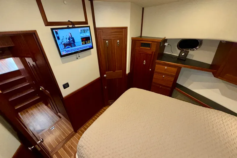 Slide: The Image of Interior of 2016 Nordic Tug 44 with wood paneling and mounted TV. - 82