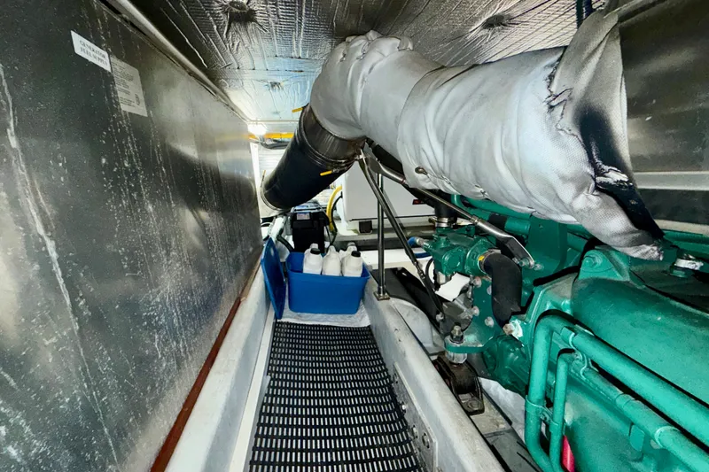 Slide: The Image of Engine room of a 2016 Nordic Tug 44, featuring machinery and storage containers. - 87
