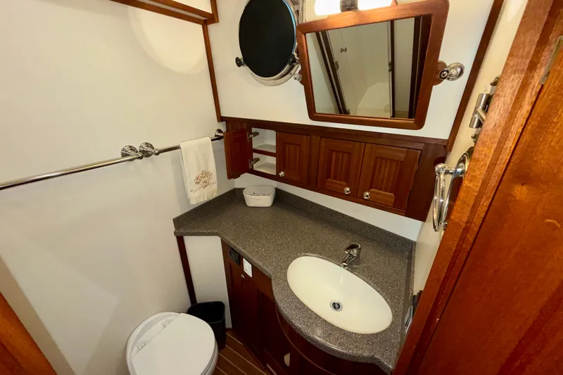 Slide: The Image of Bathroom interior of 2016 Nordic Tug 44 with wooden cabinetry and modern fixtures. - 83