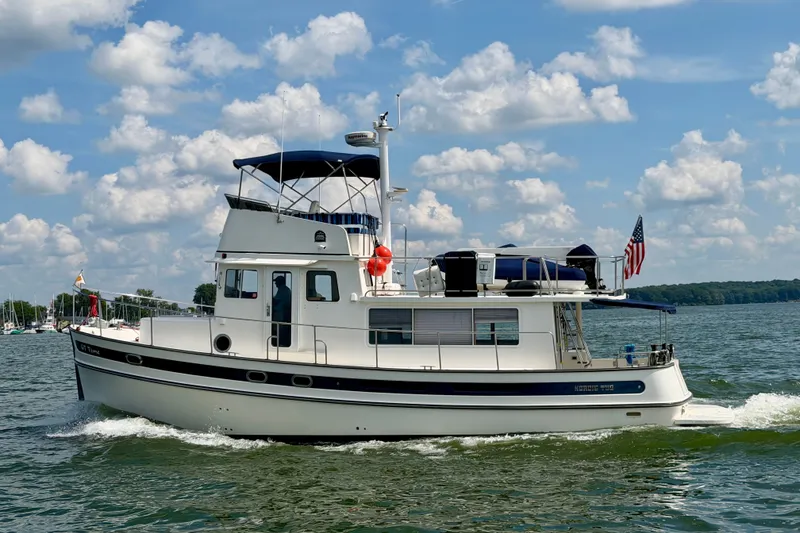 The Image of 2016 Nordic Tug 44 cruising on a sunny day with American flag. - 0