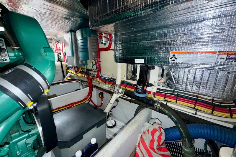Slide: The Image of Engine room of a 2016 Nordic Tug 44 with visible wiring and machinery. - 90