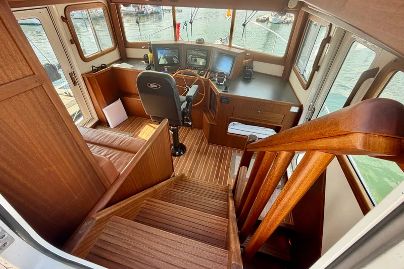 Slide: The Image of Pilothouse interior of 2016 Nordic Tug 44 with wooden finishes and navigation equipment. - 50