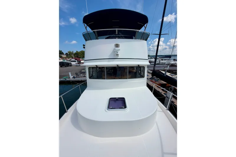 Slide: The Image of 2016 Nordic Tug 44 yacht docked, featuring a spacious deck and sleek design. - 8