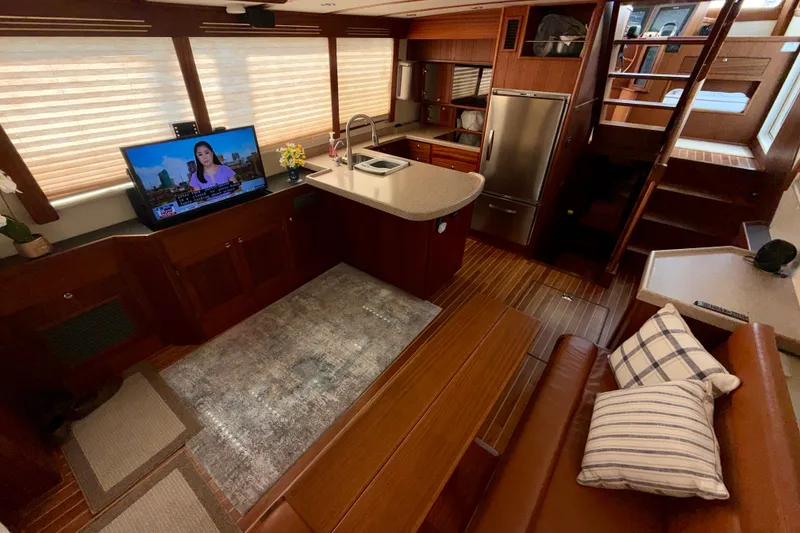 Slide: The Image of Luxurious 2016 Nordic Tug 44 interior with modern kitchen, TV, and cozy seating area. - 35