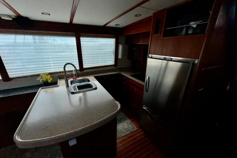 Slide: The Image of 2016 Nordic Tug 44 yacht kitchen with modern appliances and sleek countertops. - 40