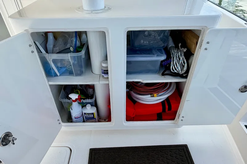 Slide: The Image of Storage compartment on a 2016 Nordic Tug 44, containing ropes, cleaning supplies, and safety equipment. - 15