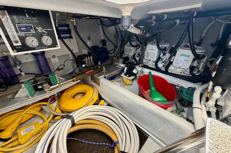 Slide: The Image of Engine room of a 2016 Nordic Tug 44, featuring hoses, gauges, and maintenance equipment. - 112
