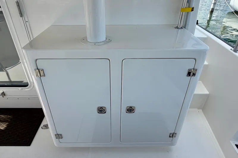 Slide: The Image of White storage cabinet on 2016 Nordic Tug 44 boat deck. - 14