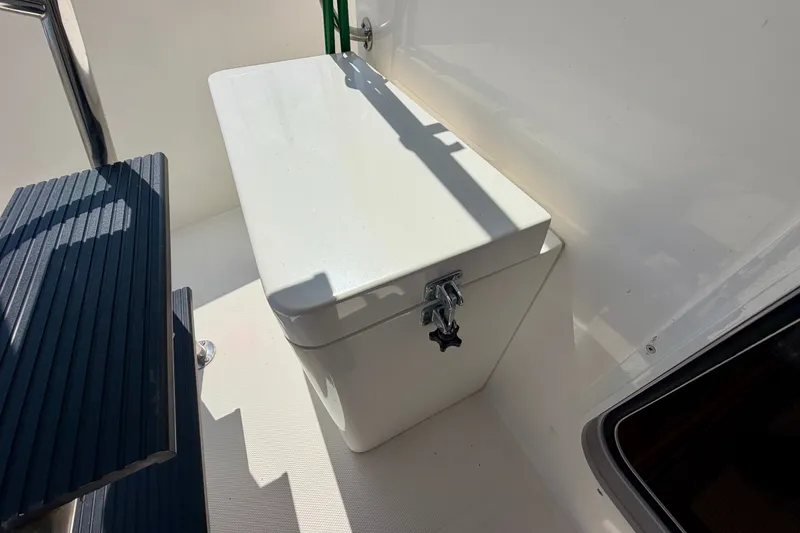 Slide: The Image of White storage box on 2016 Nordic Tug 44 boat deck, with metal latch and adjacent seating. - 16