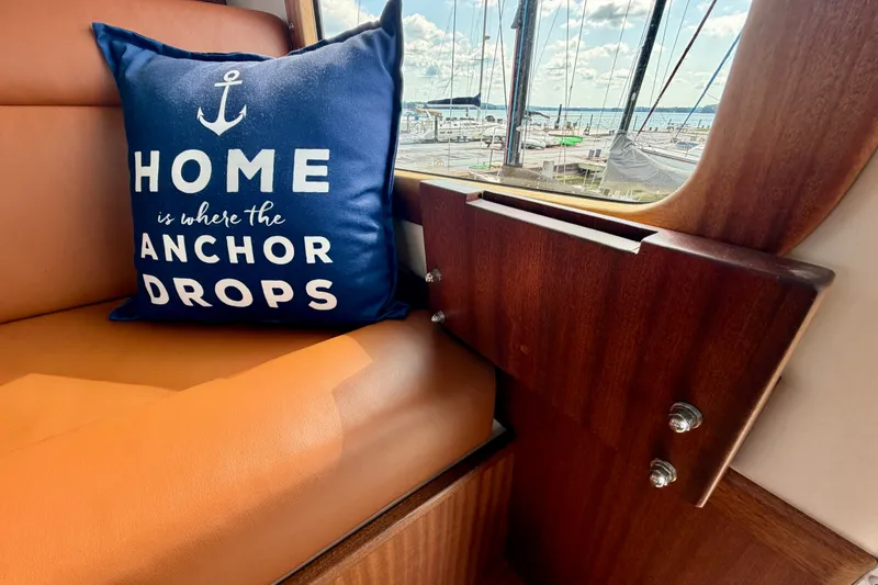 Slide: The Image of Cozy Nordic Tug 44 interior with nautical-themed pillow, marina view. - 53