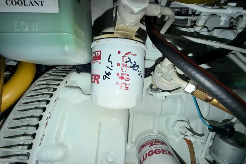 Slide: The Image of Engine compartment of a 2016 Nordic Tug 44 with visible oil filter and coolant. - 98