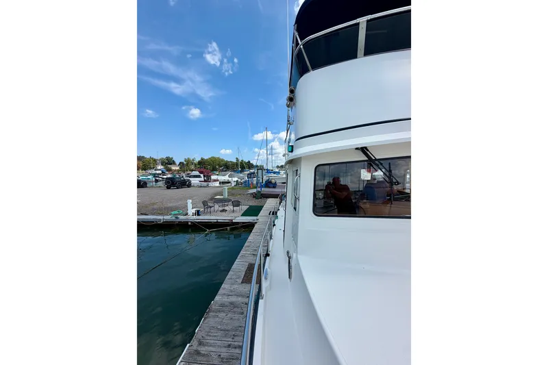 Slide: The Image of Nordic Tug 44 (2016) docked at marina under clear blue sky. - 13