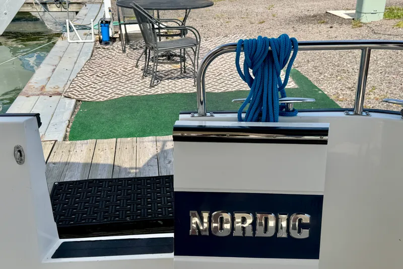 Slide: The Image of Nordic Tug 44 boat stern with blue rope, dockside view, 2016 model. - 18