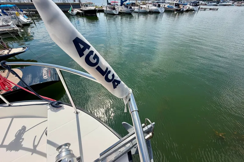 Slide: The Image of Nordic Tug 44 (2016) docked at marina, view of bow and water. - 10