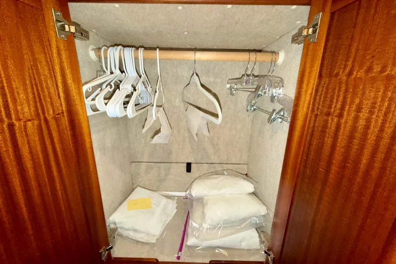 Slide: The Image of Wooden closet with hangers and bedding inside Nordic Tug 44, 2016 model. - 76