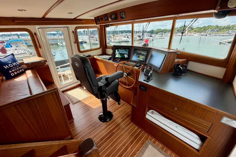 Slide: The Image of Pilothouse of 2016 Nordic Tug 44 with wooden interior and navigation equipment. - 44