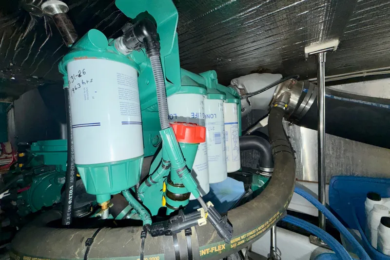 Slide: The Image of Engine room of a 2016 Nordic Tug 44 with visible filters and hoses. - 93