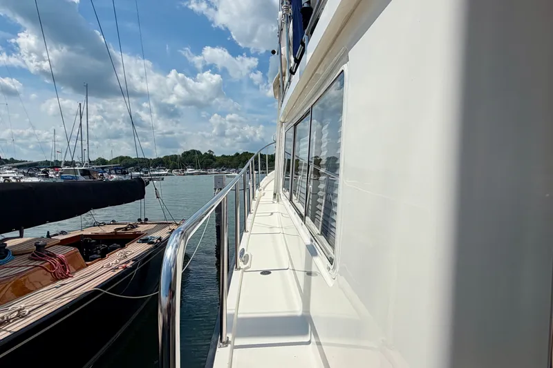 Slide: The Image of Side view of a 2016 Nordic Tug 44 yacht docked at a marina under a blue sky. - 7