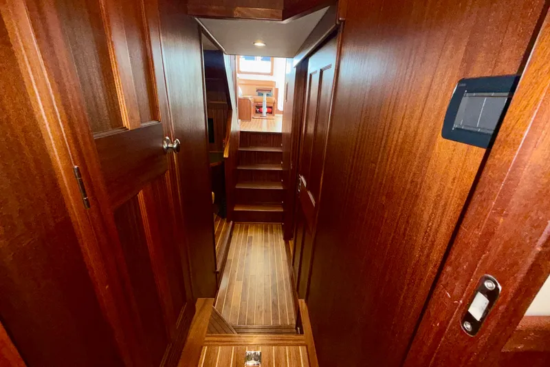 Slide: The Image of Luxurious wooden interior of a 2016 Nordic Tug 44 yacht, featuring elegant stairs and doors. - 78