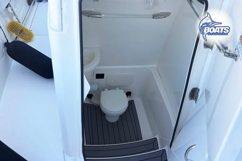 Slide: The Image of 2023 Cobia 262 Center Console boat interior with compact marine toilet. - 7