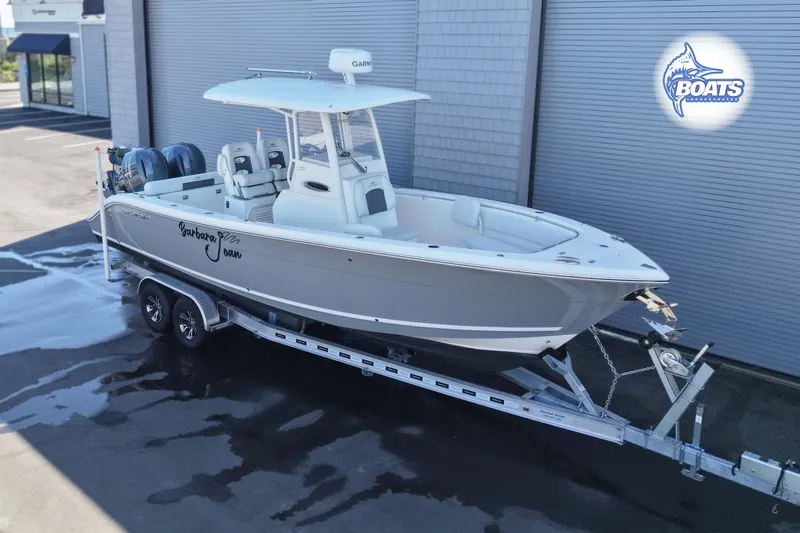 Slide: The Image of 2023 Cobia 262 Center Console boat on trailer, parked outdoors. - 1