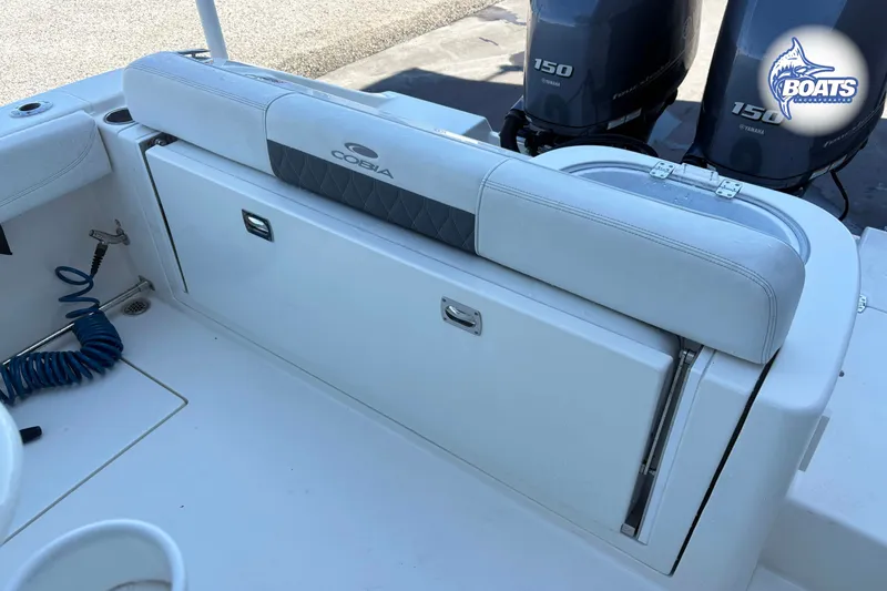 Slide: The Image of 2023 Cobia 262 Center Console boat interior with Yamaha engines and seating area. - 11