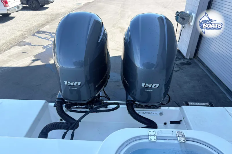 Slide: The Image of Twin Yamaha 150 engines on a 2023 Cobia 262 Center Console boat. - 13