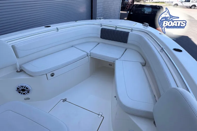 Slide: The Image of 2023 Cobia 262 Center Console boat interior with white seating and speaker. - 5