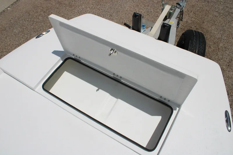 Slide: The Image of Open storage compartment on 2027 Freedom Boats Chiquita, showing interior space and trailer. - 12